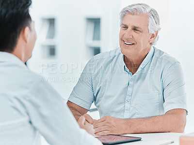 Buy stock photo Shot of a mature man sitting with his doctor during a consultation in the clinic