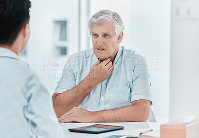 Buy stock photo Shot of a mature man sitting with his doctor and complaining about a sore throat during a consultation