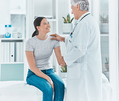Buy stock photo Shot of a senior doctor shaking hands with a patient in greeting