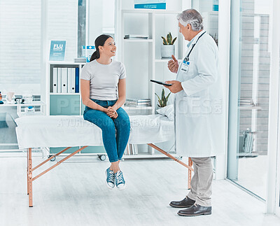 Buy stock photo Shot of a doctor discussing a patients results with her using a digital tablet