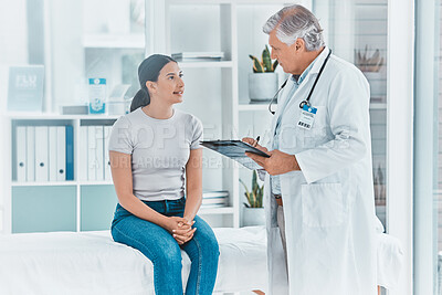Buy stock photo Shot of a doctor recording a patients information on their medical chart