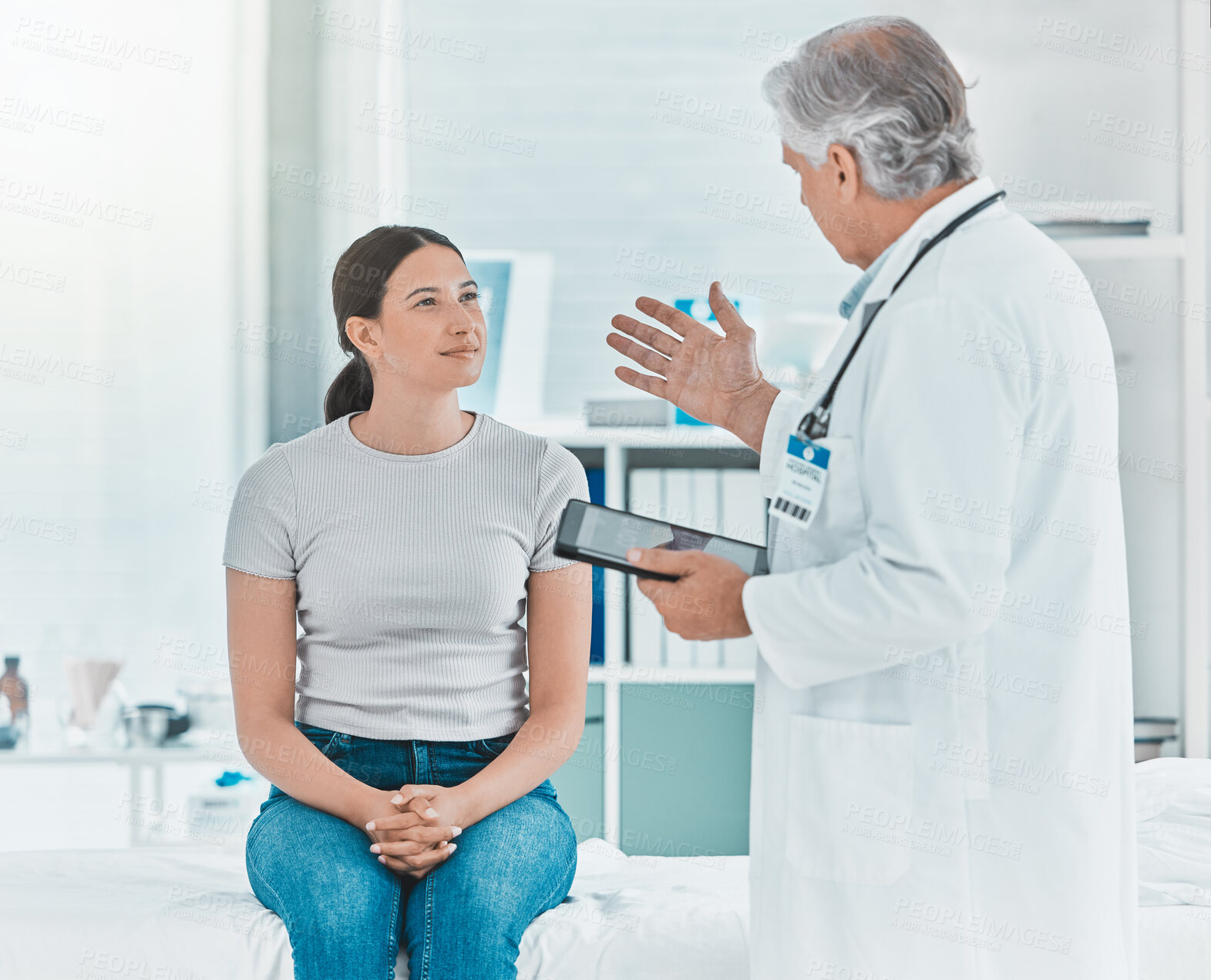 Buy stock photo Shot of a doctor discussing a patients results with her using a digital tablet