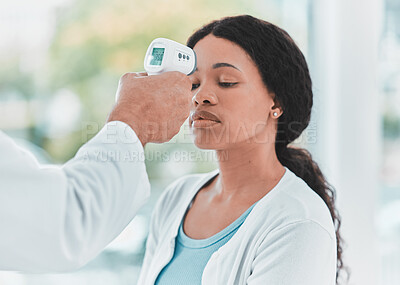 Buy stock photo Shot of a doctor scanning a patients temperature using a thermometer
