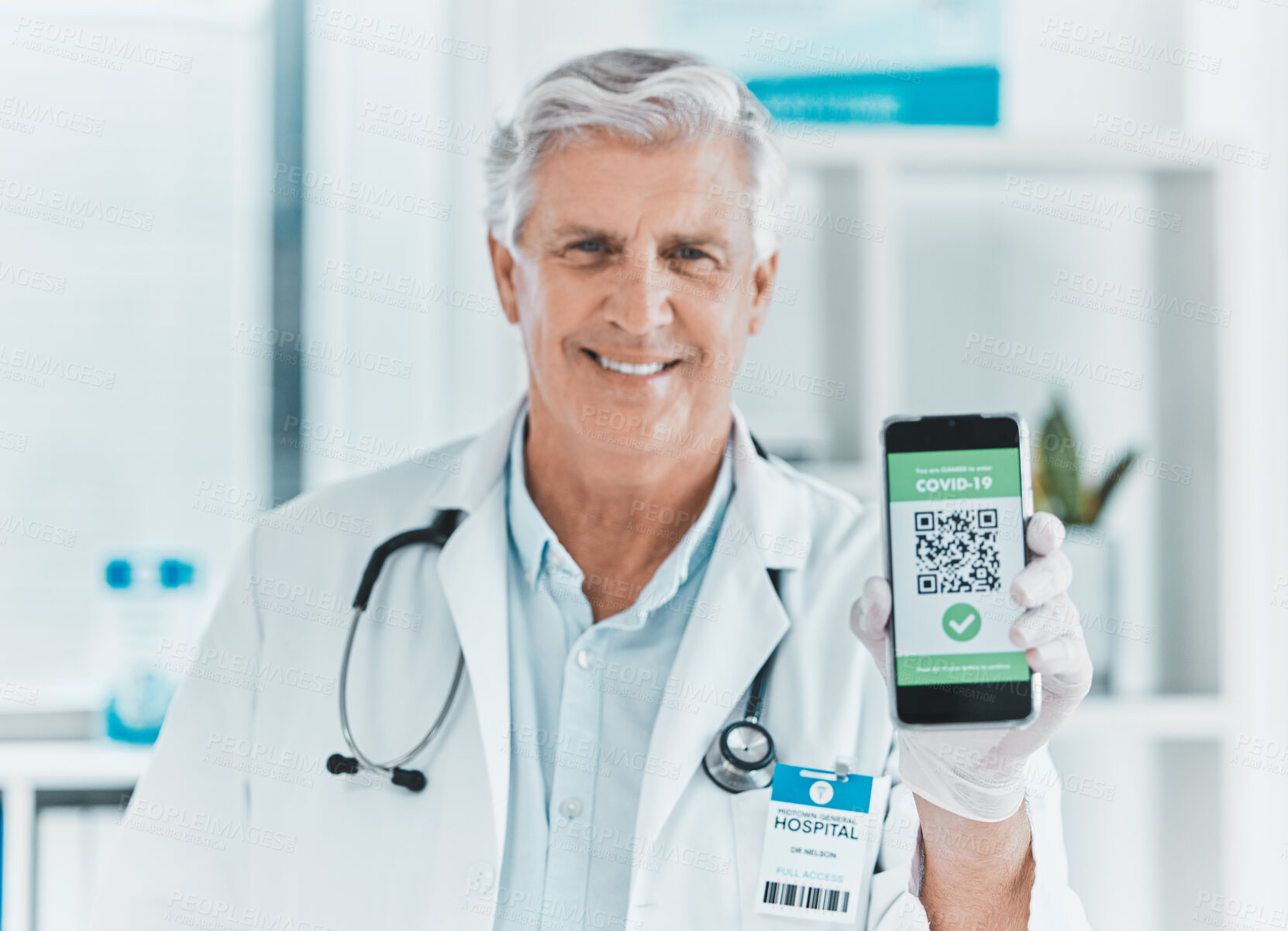 Buy stock photo Shot of a male doctor holding a smartphone depicting a QR code to be scanned