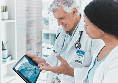 Buy stock photo Shot of a senior doctor signing a patient up for vaccination using his digital tablet
