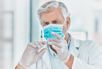 Buy stock photo Shot of a doctor preparing to administer an injection