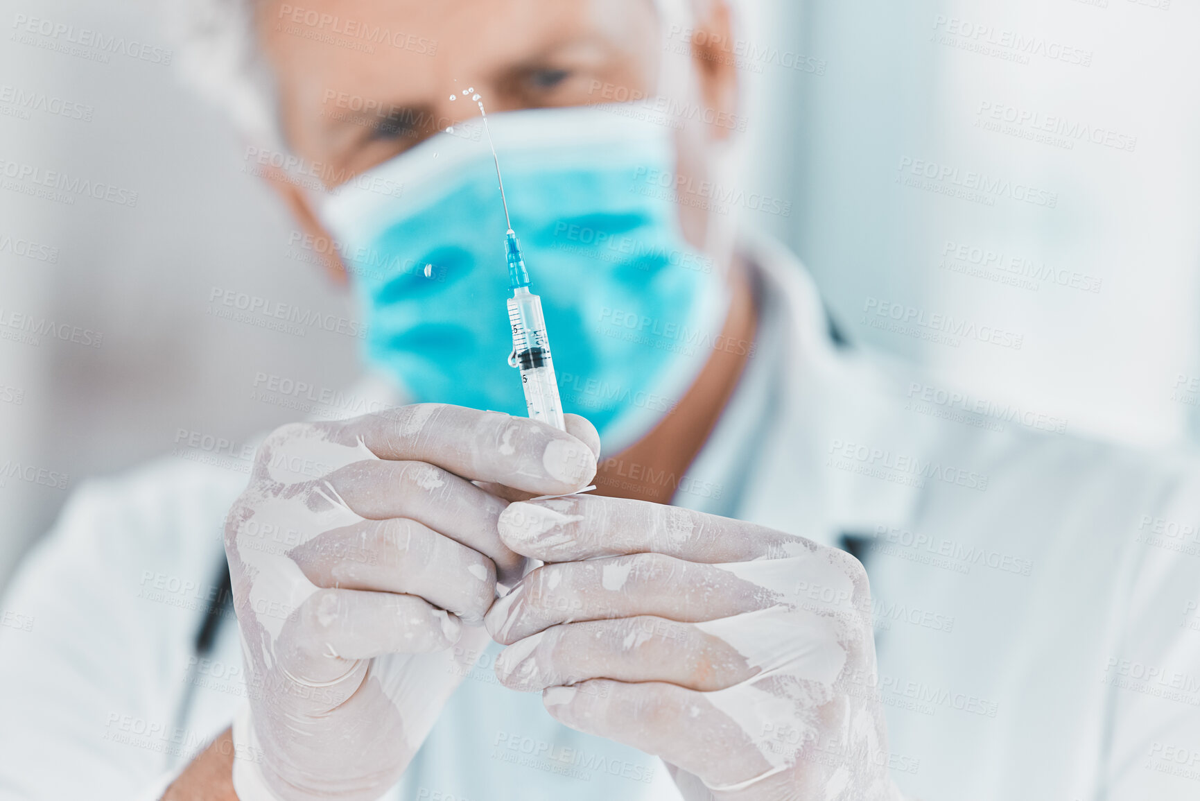 Buy stock photo Shot of a doctor preparing to administer an injection