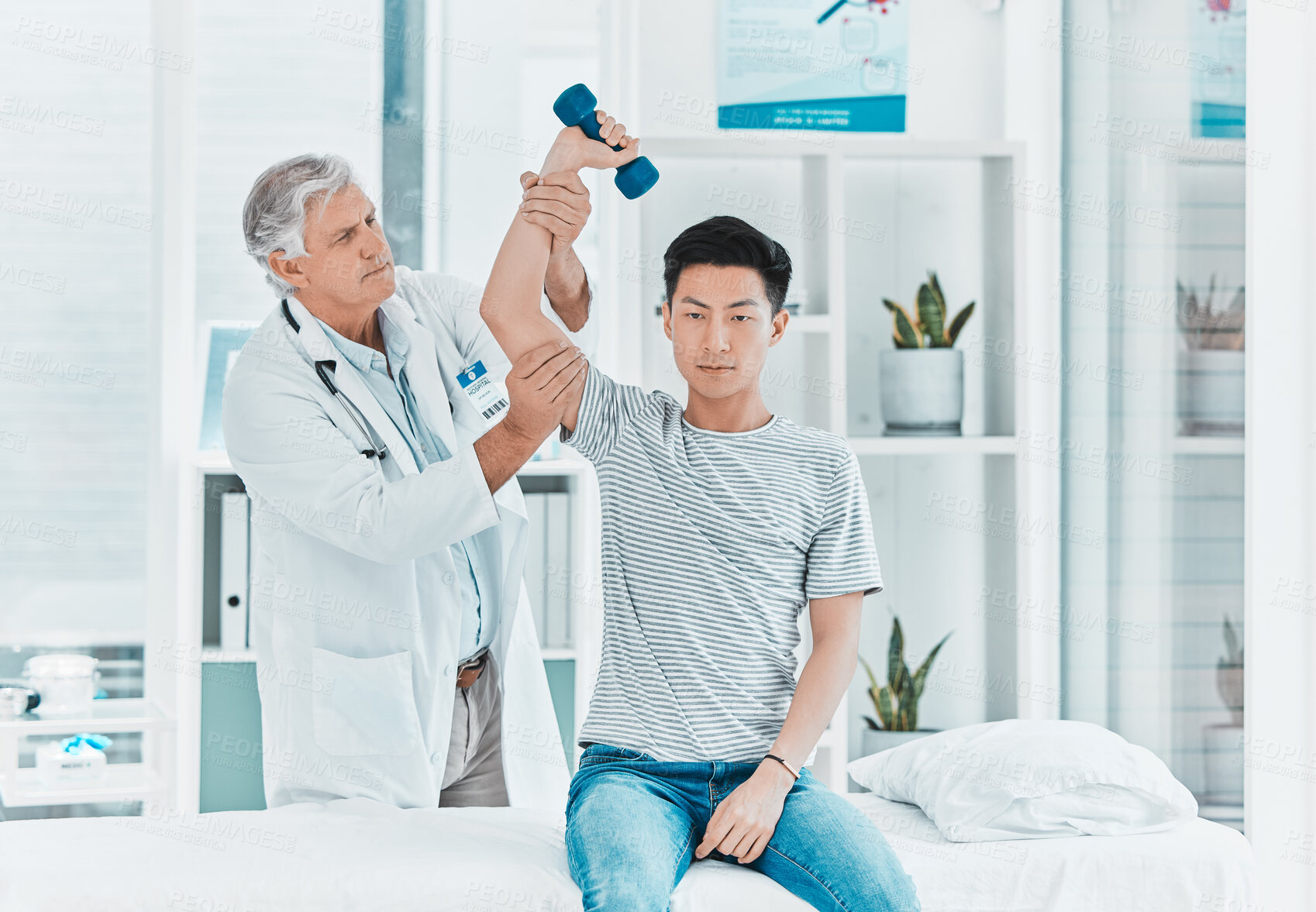 Buy stock photo Man, doctor or patient with dumbbell for physiotherapy, checkup or muscle examination at clinic. Male person, therapist or physio with client or weightlifting for arm pain, ache or sprain at hospital