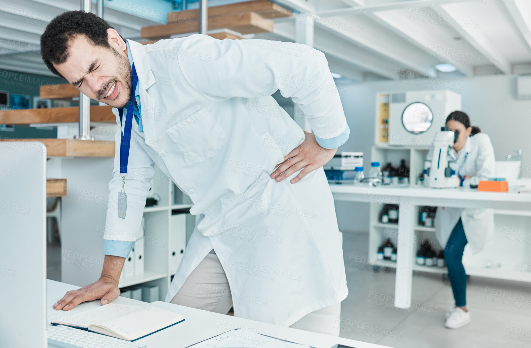 Buy stock photo Back pain, science and research with man in laboratory for stress, antibiotic resistance news and deadline. Healthcare, medical and fatigue with person for emergency, frustrated and accident