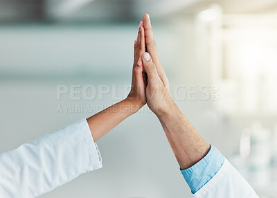 Buy stock photo Closeup shot of two unrecognisable scientists giving each other a high five in a lab