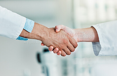 Buy stock photo Closeups shot of two unrecognisable scientists shaking hands in a lab