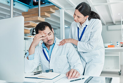 Buy stock photo Shot of a young scientist looking stressed out while being consoled by a colleague in a lab