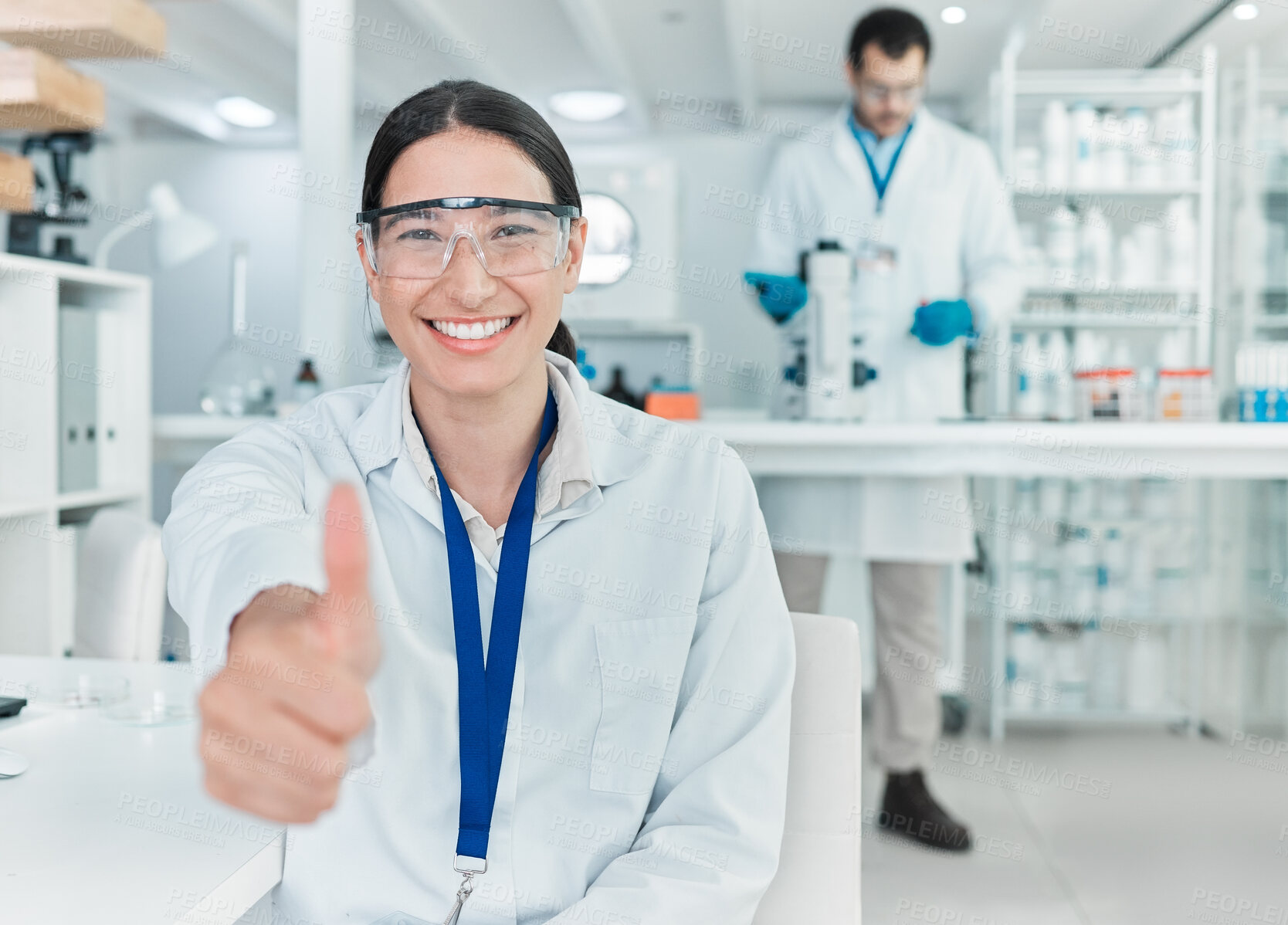 Buy stock photo Portrait of a young scientist showing thumbs up in a lab