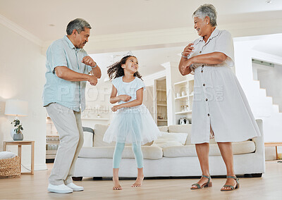 Buy stock photo Shot of grandparents dancing with their granddaughter at home