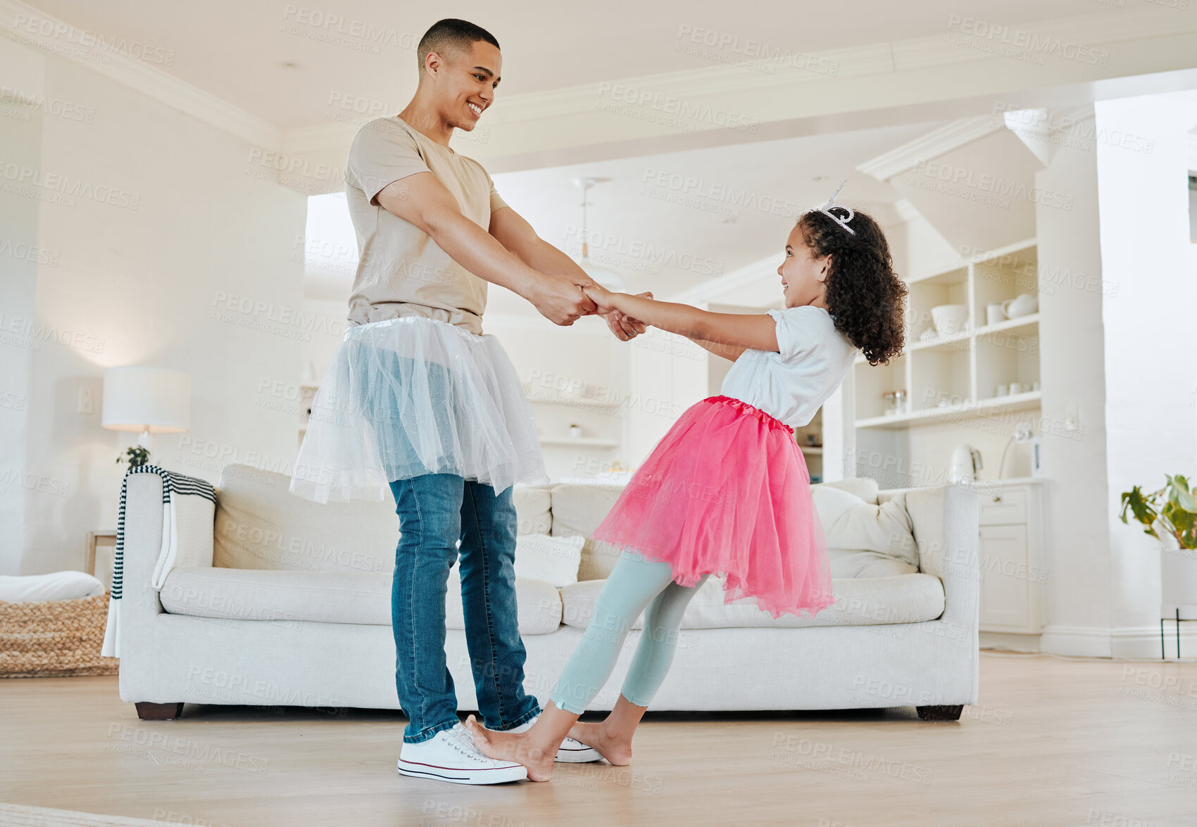Buy stock photo Shot of a father dancing with his daughter in the living room at home