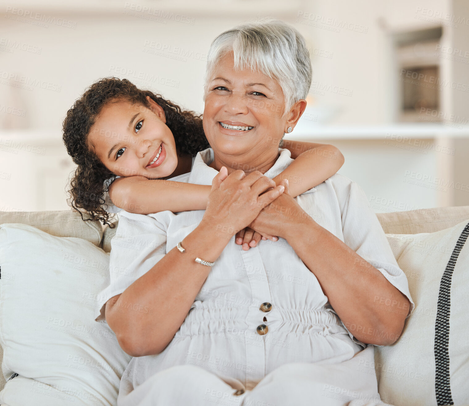 Buy stock photo Grandmother, grandchild and smile in portrait on sofa with hugging, weekend visit and bonding in home. Happy family, senior woman and girl kid with embrace on couch in living room with love and care