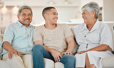 Buy stock photo Shot of a mature couple bonding with their son on the sofa at home