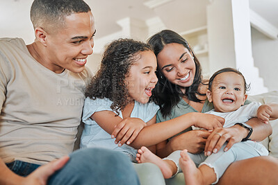 Buy stock photo Shot of a beautiful family bonding on a sofa at home