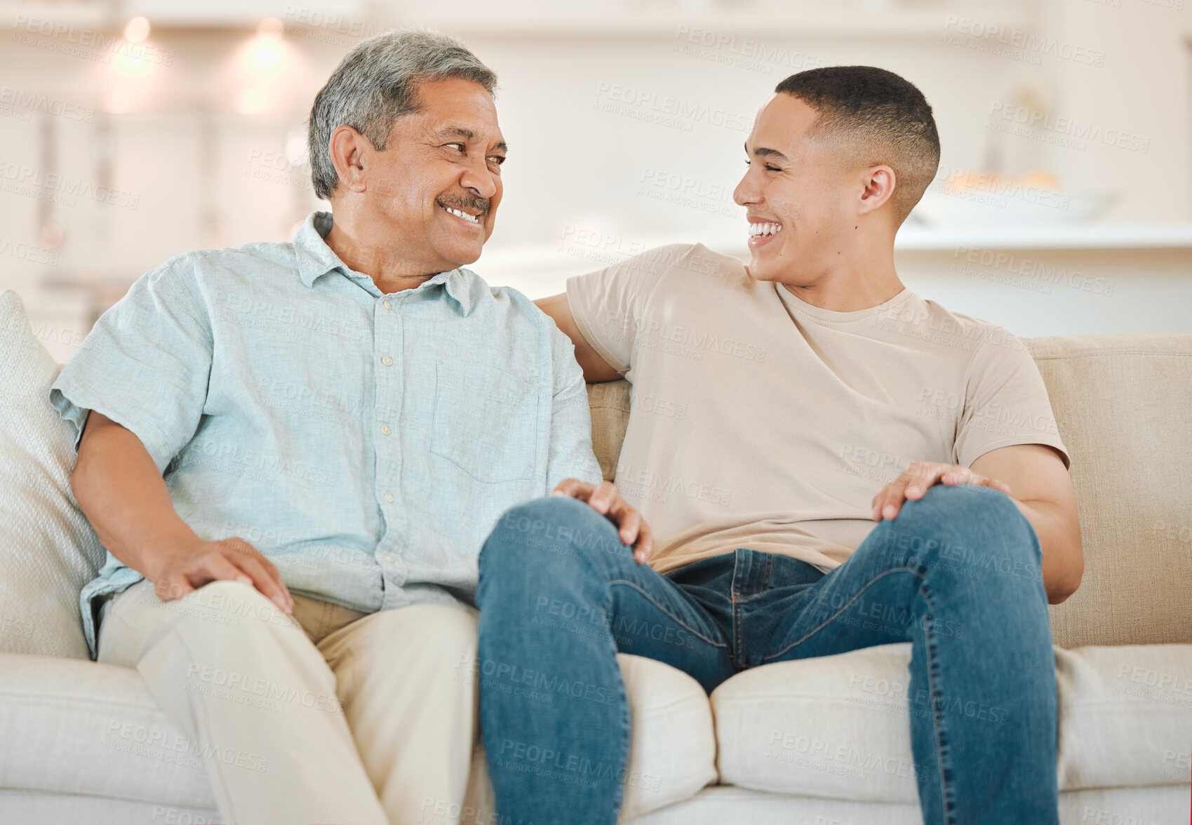 Buy stock photo Shot of a father and son bonding on the sofa at home