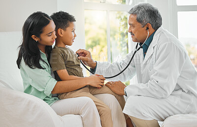 Buy stock photo Doctor checking a child with a stethoscope on a sofa in the living room for home consultation. Healthcare, wellness and mother sitting with her boy kid for male medical worker to listen to breathing.