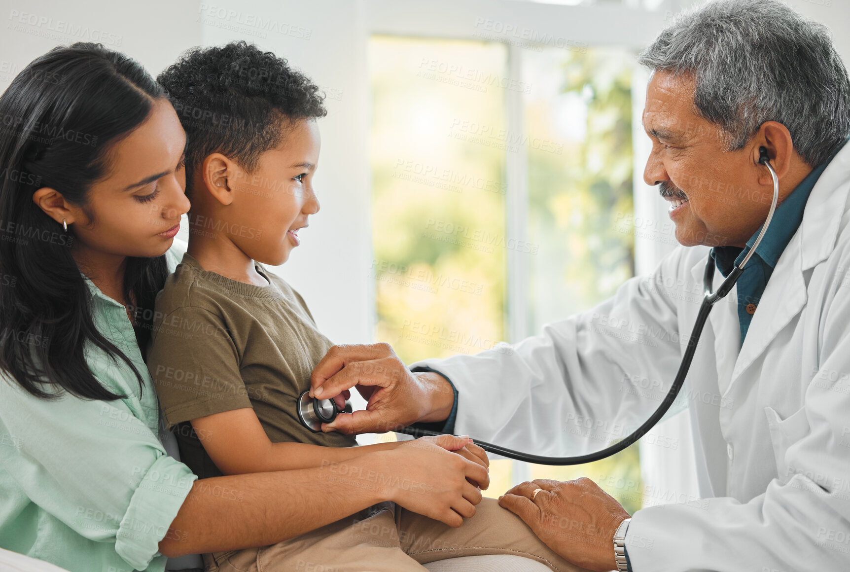 Buy stock photo Doctor checking a kid patient with stethoscope on a sofa for home medicare consultation. Healthcare, pediatrician and mother sitting with her boy child for male medical worker to listen to breathing.