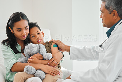 Buy stock photo Doctor, woman and child with bandage plaster and vaccine for growth or development in clinic. Mother, boy and pediatrician with comfort at hospital for immunity, routine checkup or illness prevention