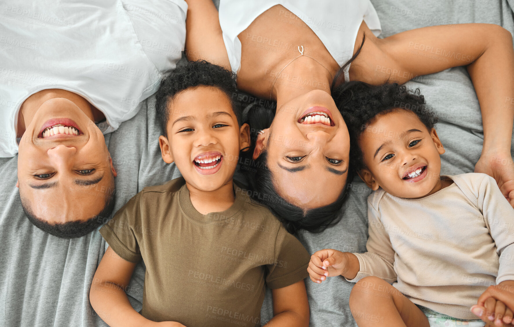 Buy stock photo Happy, portrait and children with parents on bed for bonding, fun and connection together in home. Relax, care and top view of boy kids resting with mom and dad in bedroom for security in house.