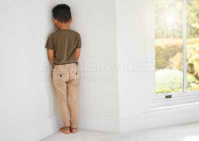 Buy stock photo Back, child and sad in corner for discipline, behavior development and time out at home. Punishment, naughty kid and stand at wall for domestic abuse, fear and depression or anxiety for mistake