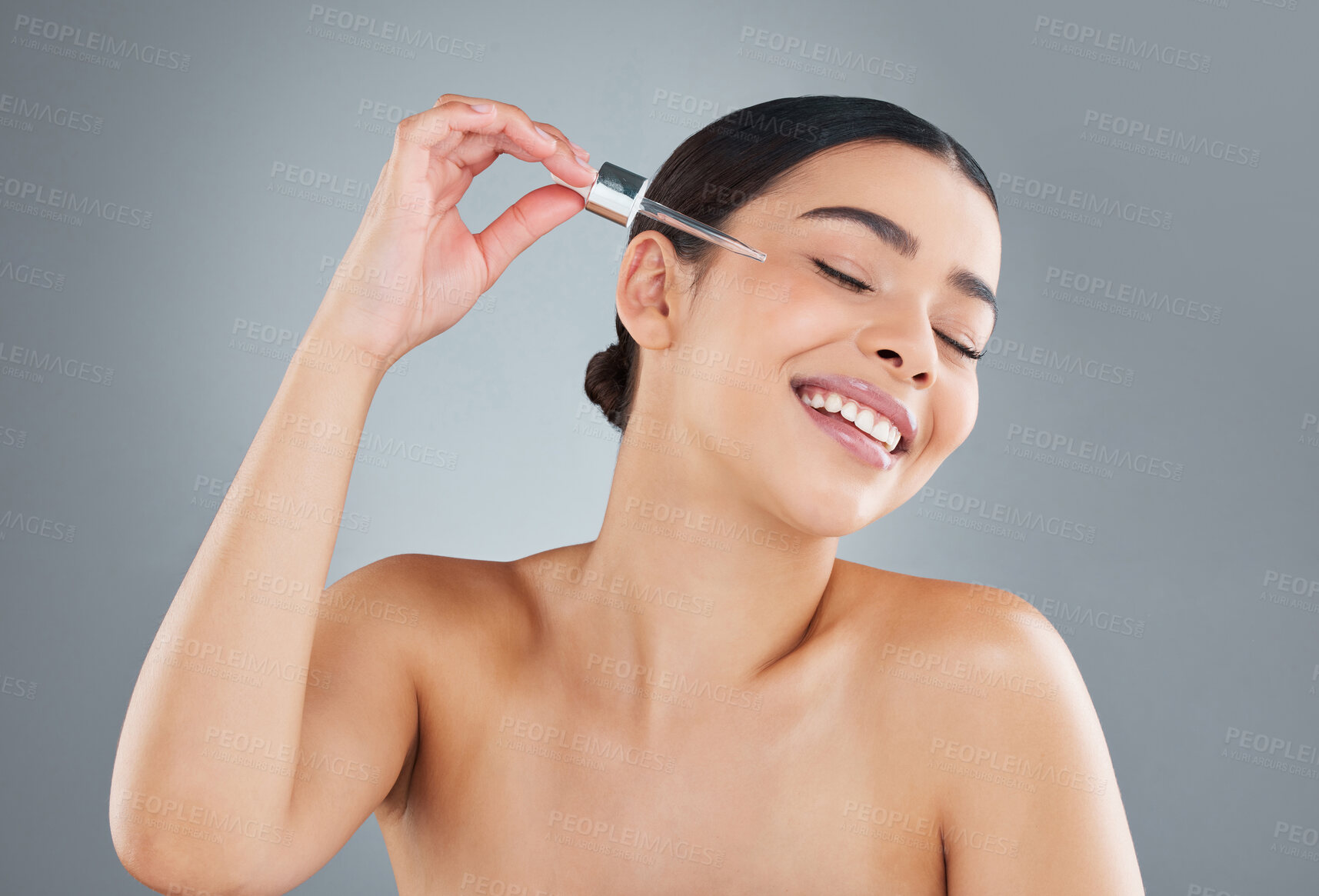 Buy stock photo Cropped shot of an attractive young woman posing in studio against a grey background