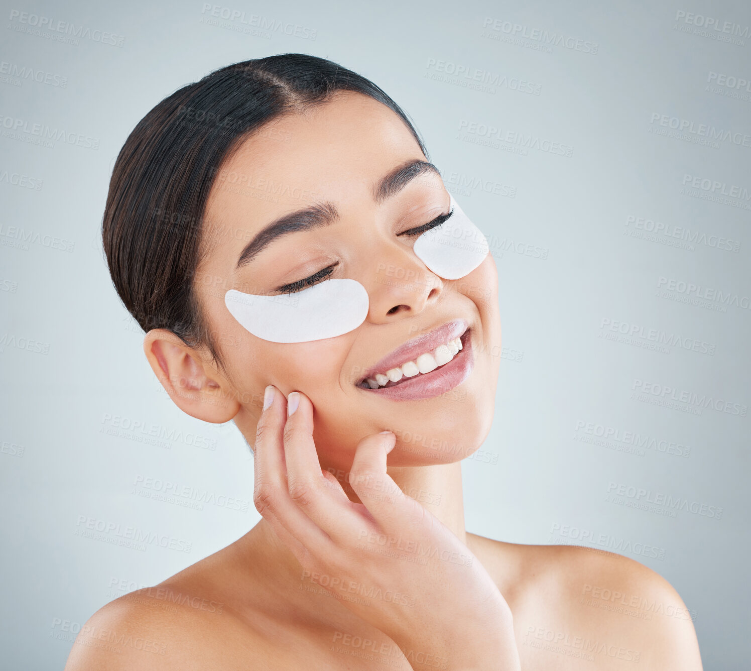 Buy stock photo Woman, eye patch and happy in studio for skincare, dermatology and collagen or revitalize product for dark circles. Grey background, self care and cosmetic or facial beauty, antiaging and treatment