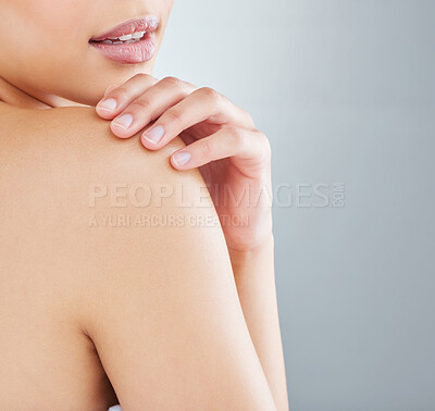 Buy stock photo Cropped shot of an unrecognizable young woman posing in studio against a grey background