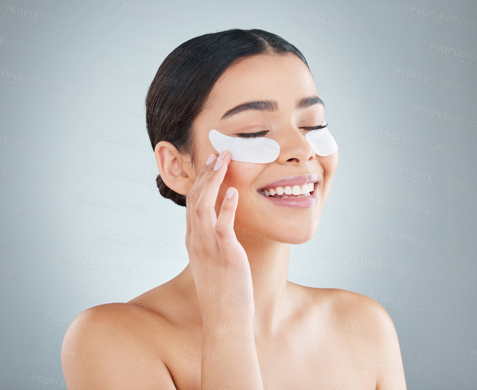 Buy stock photo Woman, eye patch and studio for skincare, happy dermatology and collagen or revitalise product for dark circles. Grey background, self care and cosmetic or facial beauty, antiaging and treatment