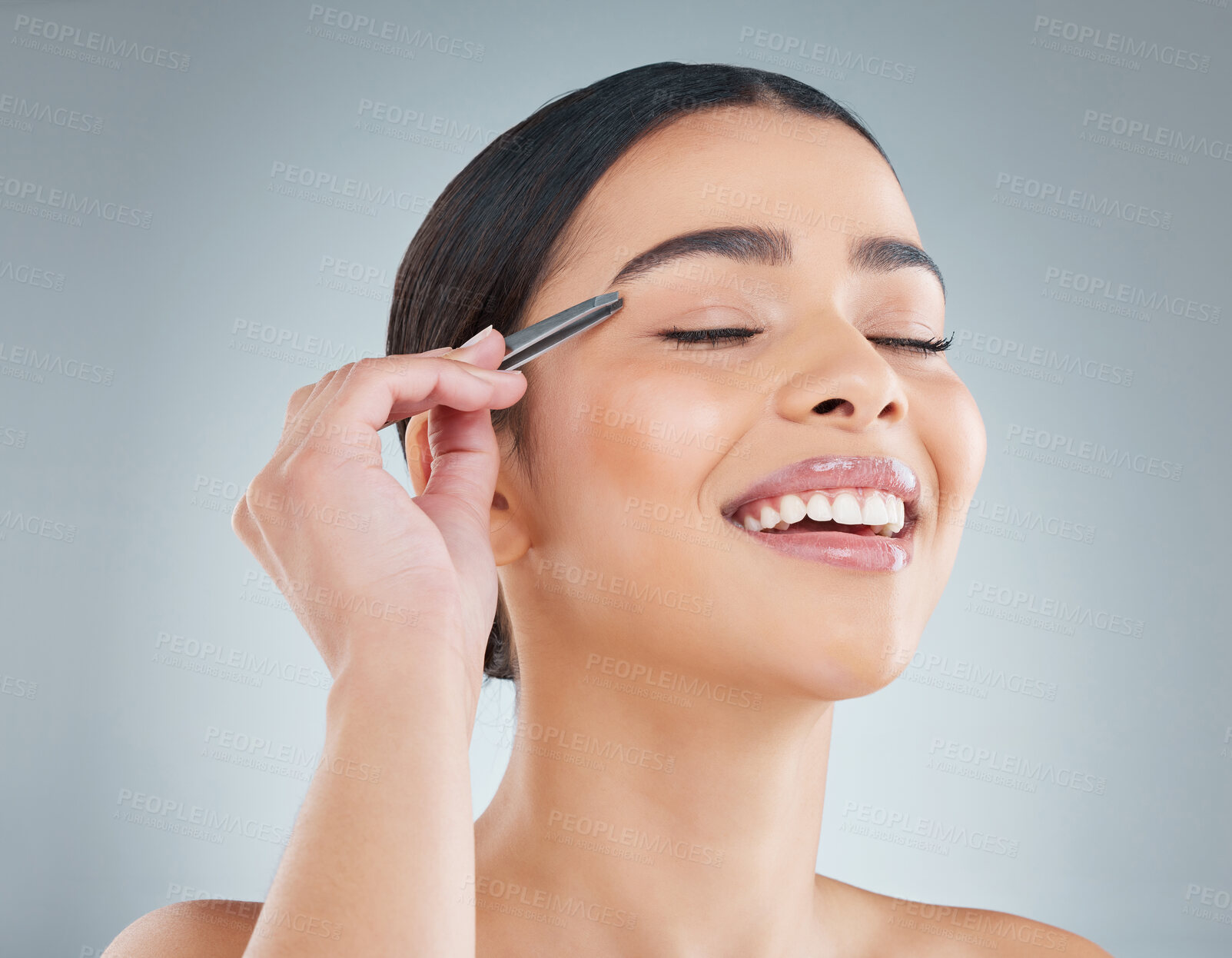 Buy stock photo Happy woman, eyebrow and tweezer on face for hair removal, skincare and beauty isolated on grey studio background. Cosmetics, facial plucking and model grooming for healthy glow, wellness or laughing