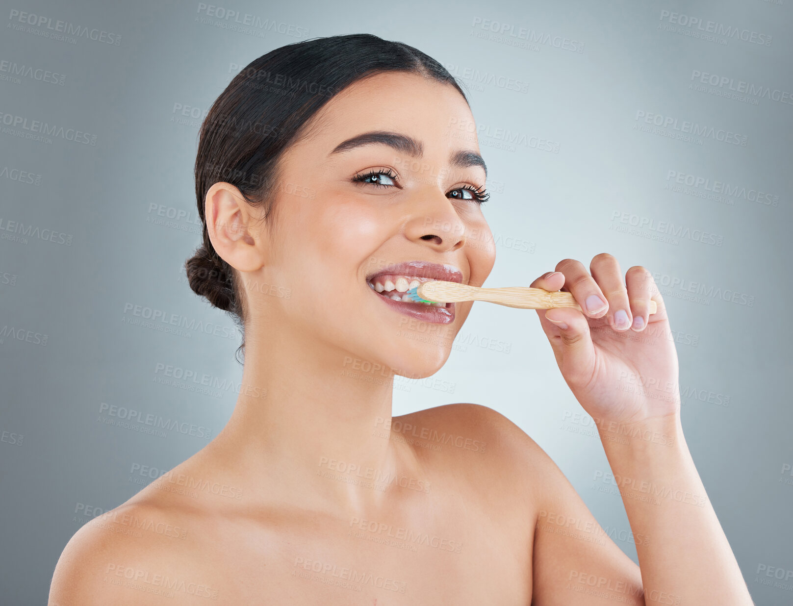 Buy stock photo Portrait, dental care and woman brushing teeth in studio for health, wellness and morning routine. Smile, clean and female person with bamboo toothbrush for oral care treatment by gray background.