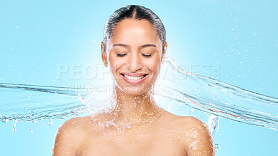 Buy stock photo Studio shot of clean water splashing against a woman's skin