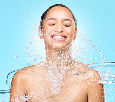 Buy stock photo Studio shot of clean water splashing against a woman's skin