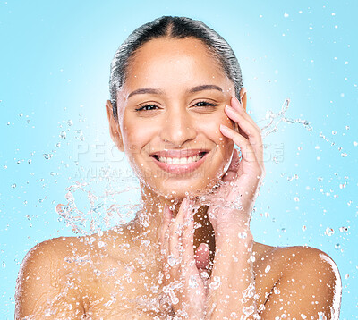 Buy stock photo Studio shot of clean water splashing against a woman's skin