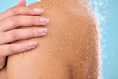 Buy stock photo Hand, woman and shower while cleaning shoulder in studio with female, washing and beauty. Water, model and wellness of a young person in bathroom for self care and dermatology by blue background