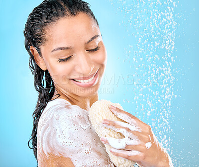 Buy stock photo Studio shot of a beautiful young woman using a loofah sponge while taking a shower