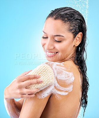 Buy stock photo Studio shot of a beautiful young woman using a loofah sponge while taking a shower