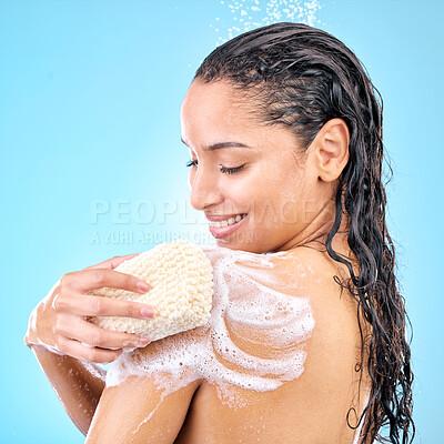 Buy stock photo Studio shot of a beautiful young woman using a loofah sponge while taking a shower