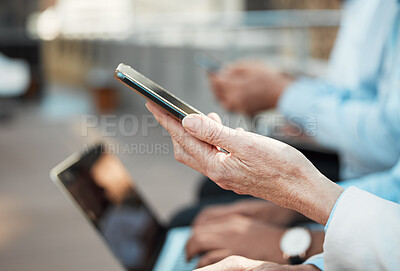 Buy stock photo Cropped shot of an unrecognisable businesswoman sitting outside with her colleagues and using her cellphone