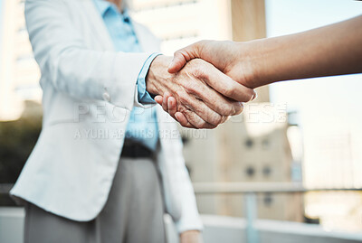 Buy stock photo Cropped shot of two unrecognisable businesspeople standing outside together and shaking hands