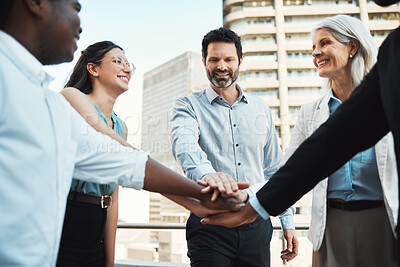 Buy stock photo Shot of a diverse group of businesspeople standing outside together and stacking her hands