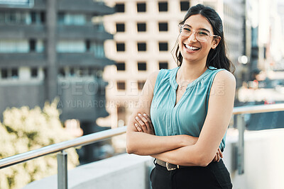 Buy stock photo Shot of an attractive young businesswoman standing alone outside with her arms folded
