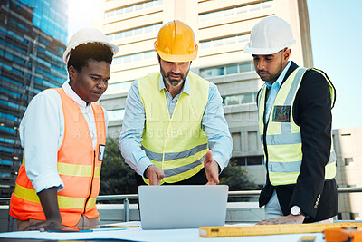 Buy stock photo Shot of a diverse group of contractors standing outside together and having a discussion while using a laptop