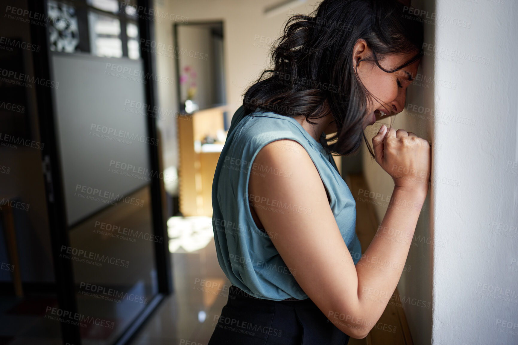 Buy stock photo Shot of an unrecognisable businesswoman standing alone in the office and feeling depressed