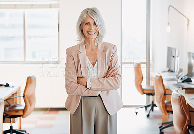 Buy stock photo Shot of a mature businesswoman standing alone in the office with her arms folded