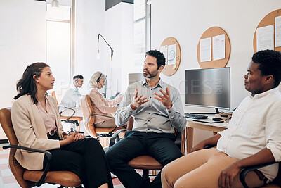 Buy stock photo Shot of a diverse group of businesspeople sitting in the office together and having a discussion
