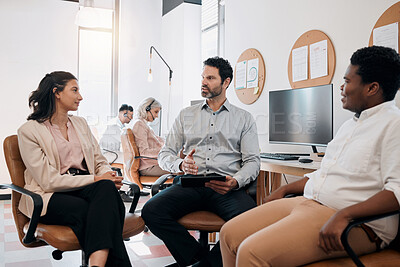 Buy stock photo Shot of a diverse group of businesspeople sitting in the office together and having a discussion